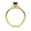 18ct recycled gold solitaire engagement ring with a baguette teal sapphire in a classic solitaire claw setting and a hand engraved band, side view