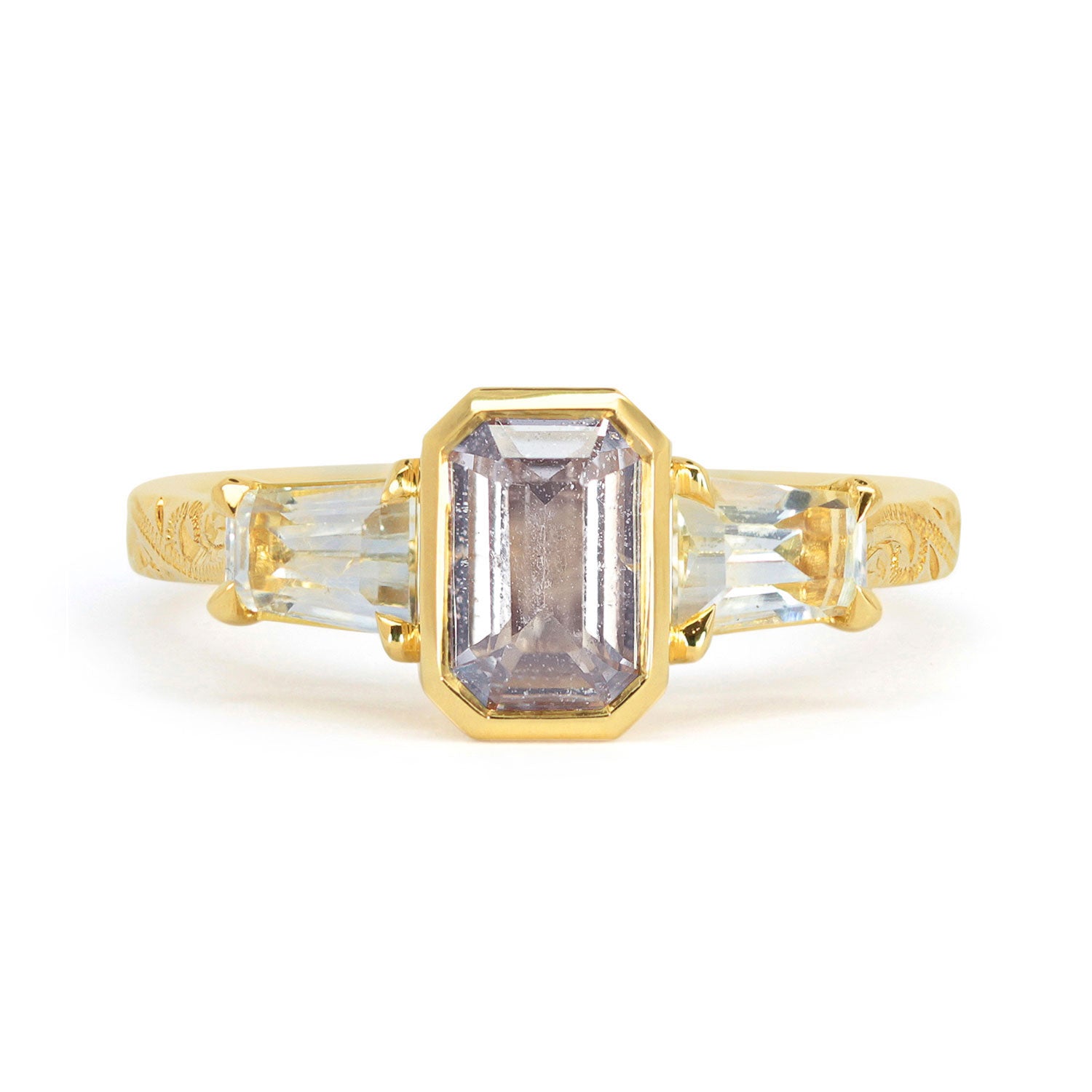 Lebrusan Studio Fancy Athena trilogy engagement ring with hand-engraved 18ct yellow Fairmined Eco Gold band and three emerald cut grey sapphires of ethical traceable origin