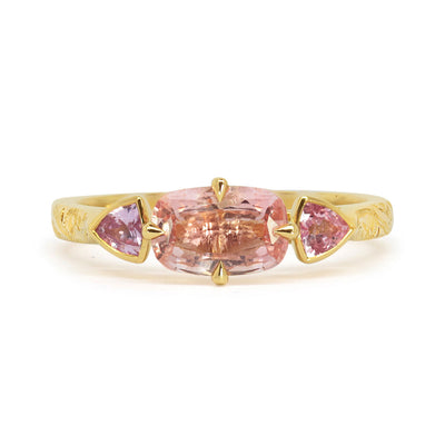 Lebrusan Studio Fancy Athena trilogy engagement ring with hand-engraved 18ct Fairmined Eco Gold, a cushion-cut pink sapphire and two trillion-cut pink sapphires