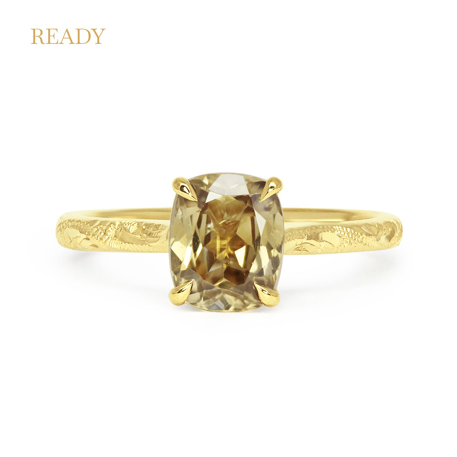 Lebrusan Studio solitaire engagement ring with hand-engraved 18ct recycled gold band and a cushion-cut gold zircon of traceable fair trade provenance