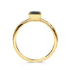 Solitaire engagement ring with a baguette-cut deep blue sapphire, secured in an 18ct recycled gold rub-over setting and a band hand-engraved with scrolls, side view