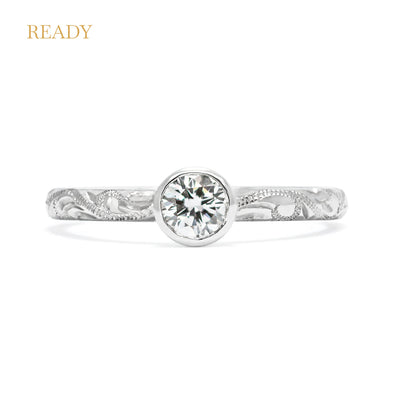 Solitaire 18ct white gold engagement ring with slim band hand-engraved with scrolls and a 0.33ct round brilliant-cut diamond in a rub-over setting