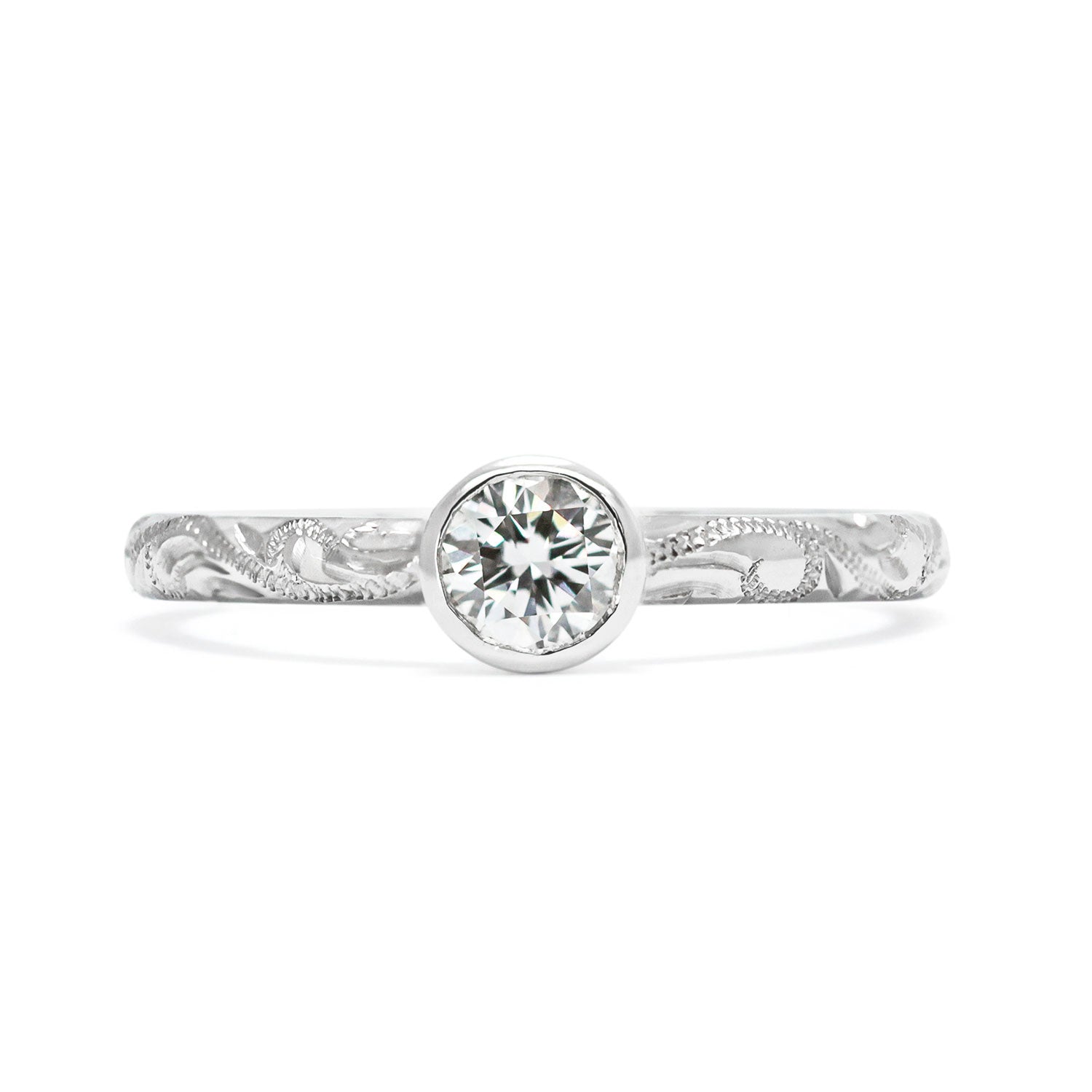 Solitaire 18ct white gold engagement ring with slim band hand-engraved with scrolls and a 0.33ct round brilliant-cut diamond in a rub-over setting