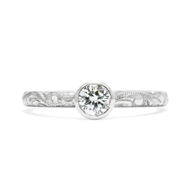 Solitaire 18ct white gold engagement ring with slim band hand-engraved with scrolls and a 0.33ct round brilliant-cut diamond in a rub-over setting