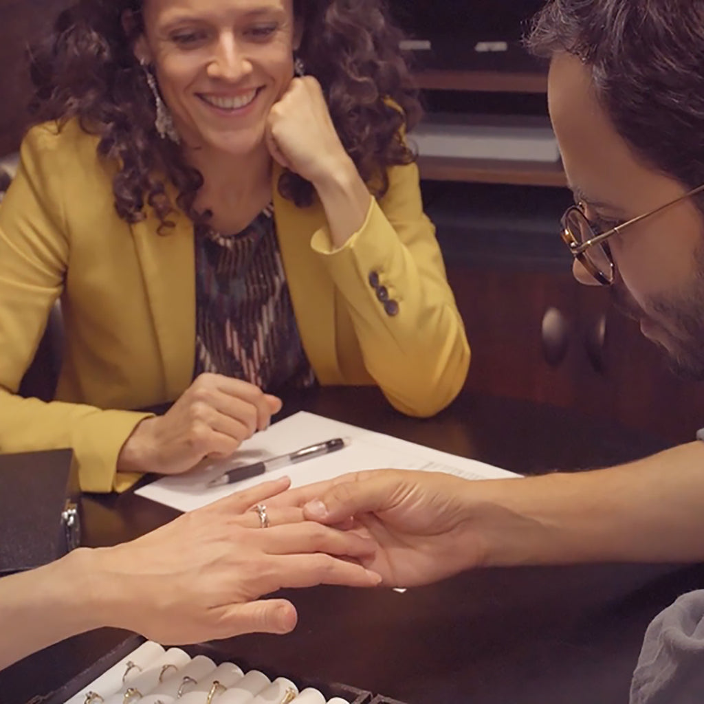 Lebrusan Studio's Creative Director Arabel Lebrusan sits with a happy couple who are trying on ethical engagement rings