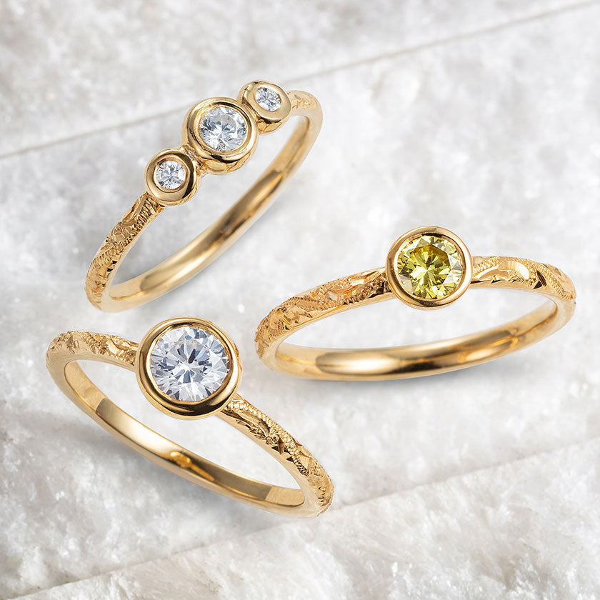 Hand-carved engagement rings with colour; conflict-free lab-grown diamonds in yellow and grey and 18ct recycled yellow gold