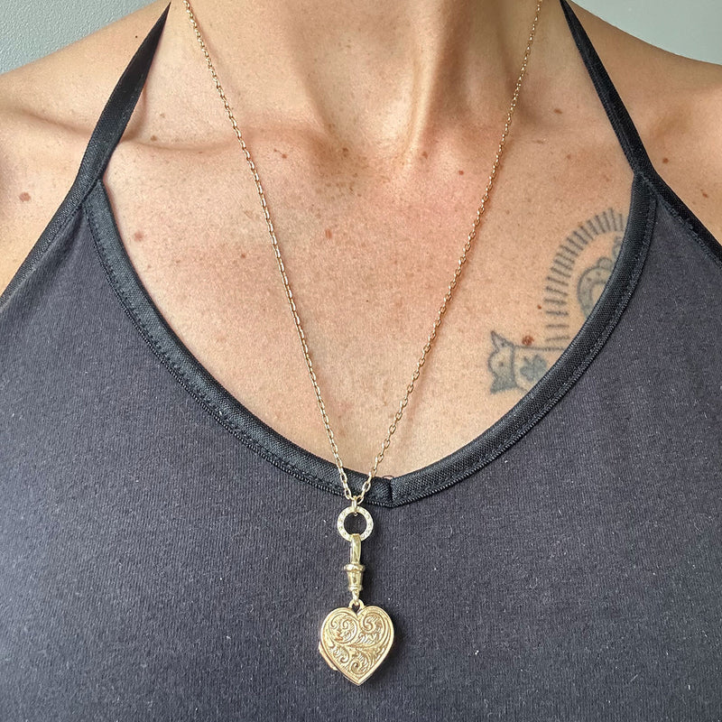 Reclaimed antique Victorian hand-engraved gold heart-shaped locket pendant necklace on a reclaimed antique gold chain, with a circlet connector in sustainable recycled gold and conflict-free Canadian diamonds