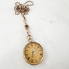 Reclaimed Vintage antique Victotrian pocket watch with Roman numerals and a decorative 'A', set with broken diamonds - repurposed as a pendant on a reclaimed antique gold chain and Albert clasp - on a white background, V2