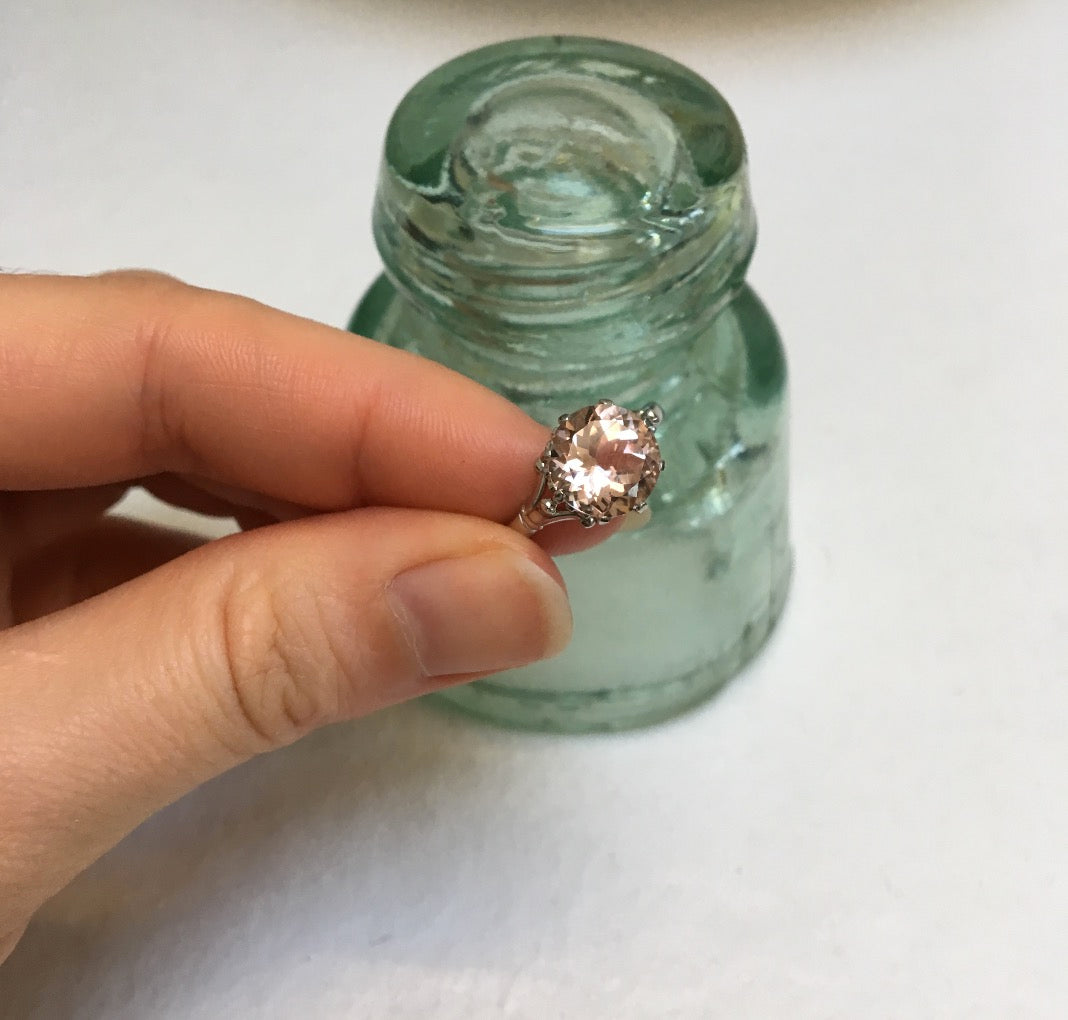 A bespoke solitaire engagement ring cast in ehical gold and set with a large peach tourmaline