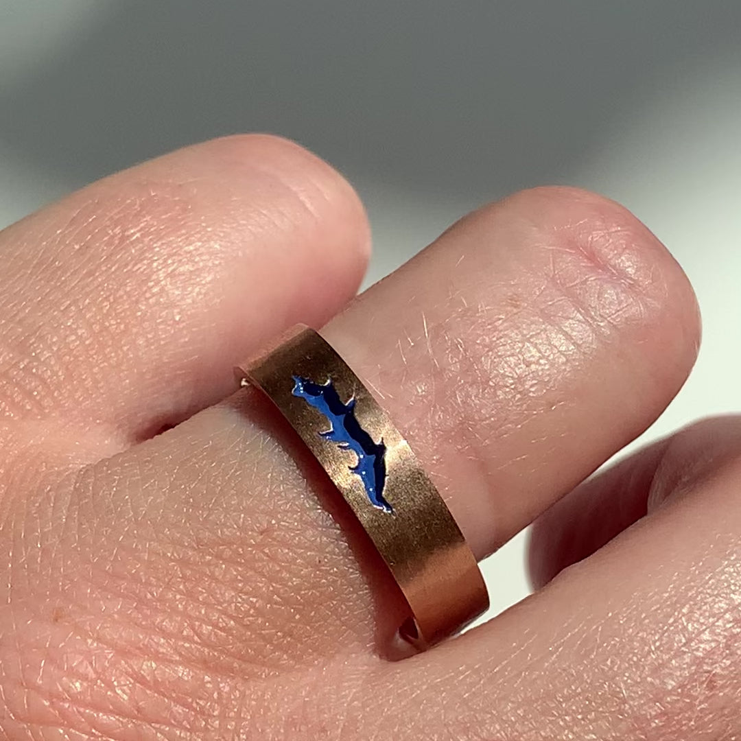 Bespoke flat court wedding band, finished with soft hammered and matte texture and a fissure inlayed with blue enamel. 9ct recycled rose gold reworked from an old heirloom piece, video