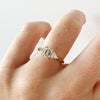 Bespoke Steve trilogy engagement ring, 18ct yellow Fairmined Ecological Gold, 0.7ct Canadamark emerald-cut diamond and trillion-cut artisanal Ocean Diamonds on hand