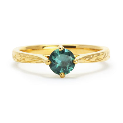 Bespoke Ed nature-inspired solitaire engagement ring, 18ct recycled yellow gold, hand-engraved fines and a traceable teal sapphire from Montana