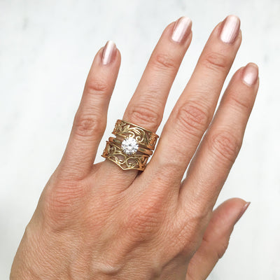 Artisan Filigree Ethical Gold Commitment Ring on hand, stacked with Artisan solitaire engagement ring and Filigree Artisan Wishbone ring, whole hand