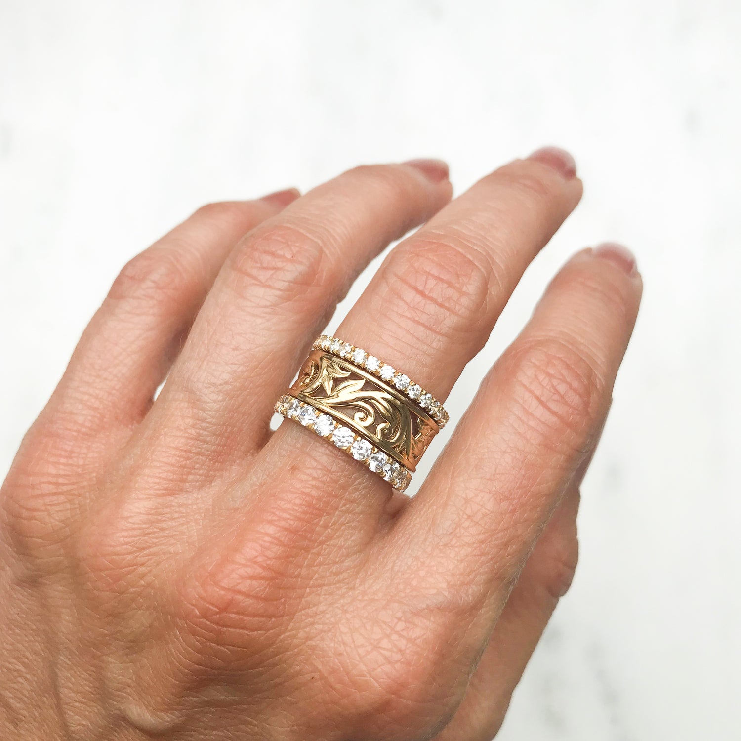 Artisan Filigree Ethical Gold Commitment Ring on hand, stacked with Altair commitment rings micro-set with conflict-free diamonds