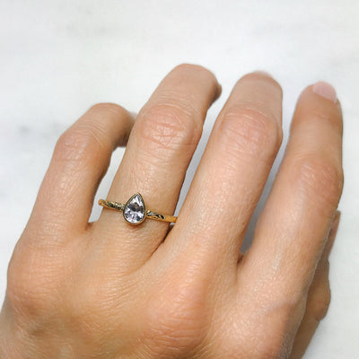 Pear-cut ice sapphire and recycled yellow gold