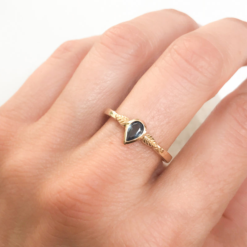 Bespoke nature-inspired engagement ring with pear-cut Malawi sapphire and 18ct recycled gold band