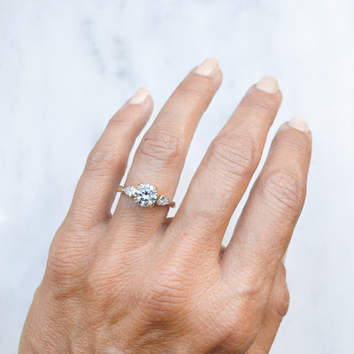 Lebrusan Studio Artisan Trilogy Engagement Ring, 1ct Ocean Diamond, 0.3ct pear-cut side Ocean Diamonds, 18ct Fairmined Ecological Gold, hand engraving, on hand