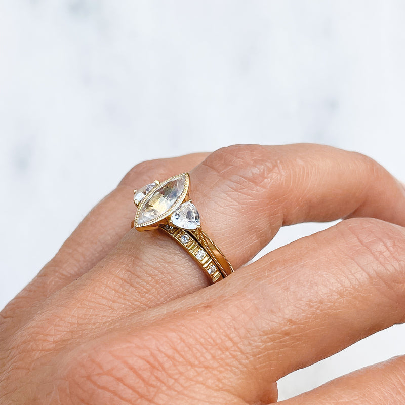 Theia ethical engagement ring, fair-traded white Sri Lankan sapphires and 18ct recycled yellow gold